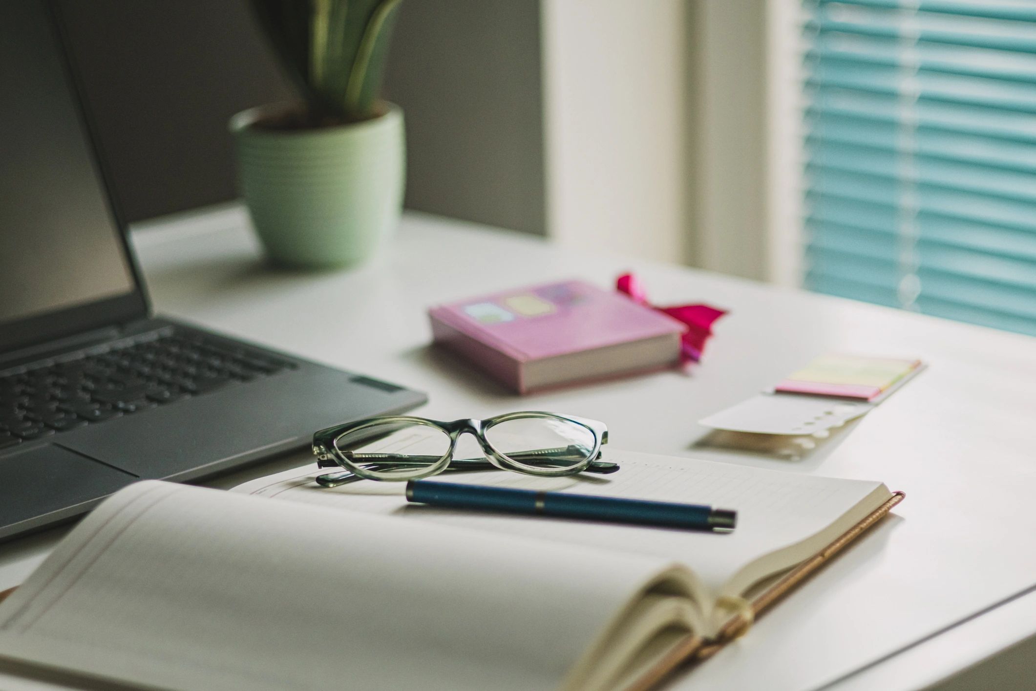 A calm writing desk with notebook and coffee