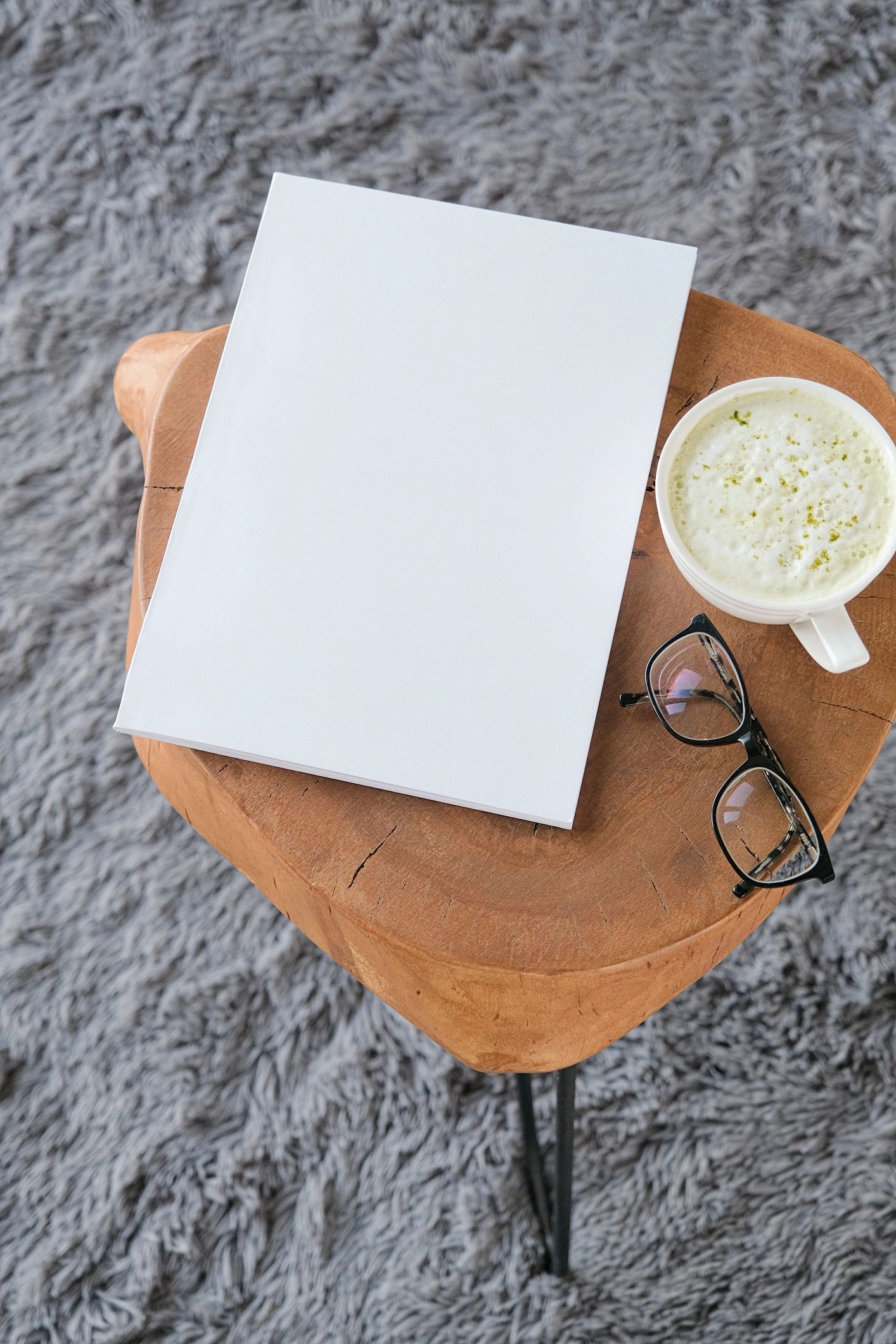 Placeholder book cover mockup on coffee table in natural light