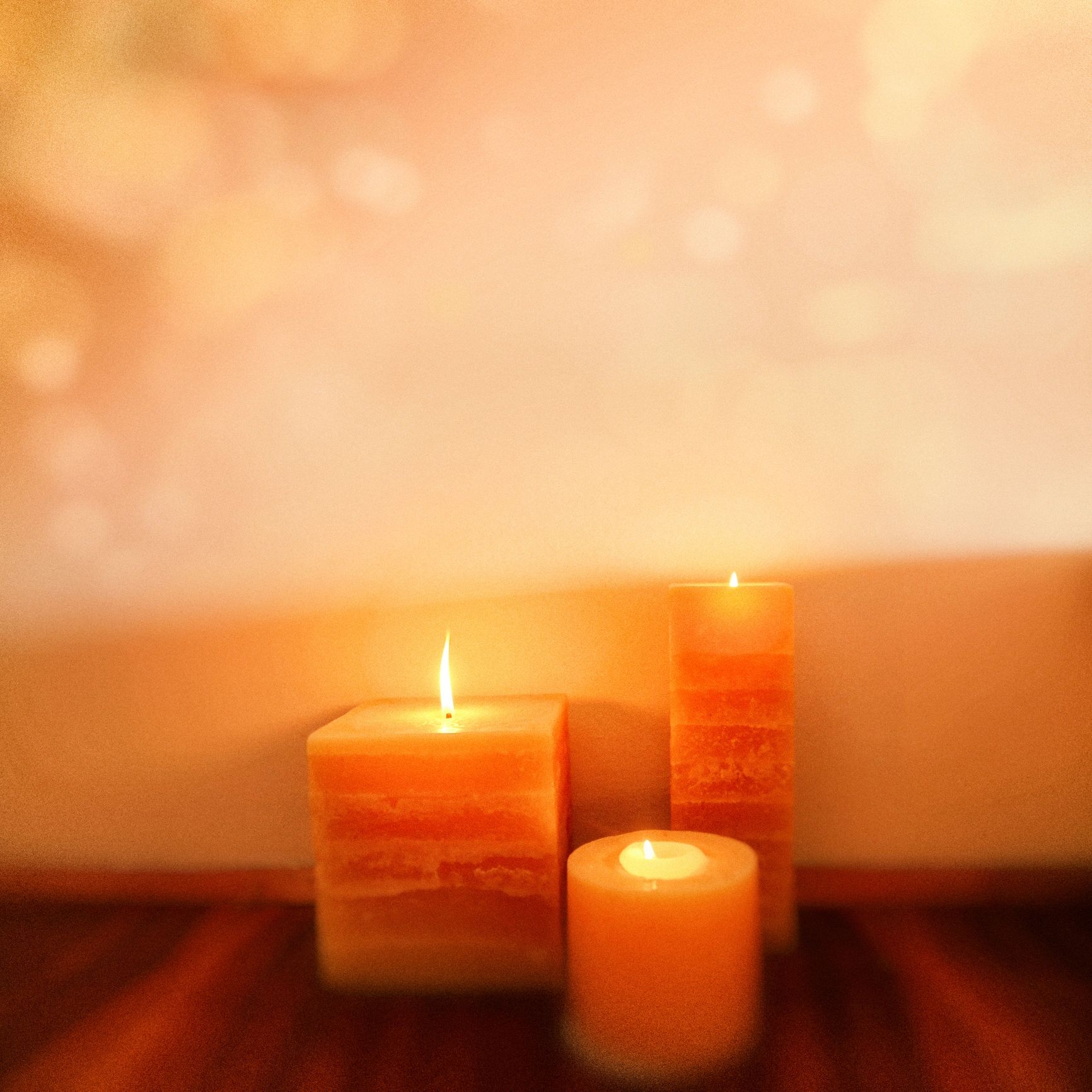 Close-up of burning candles in a dark setting